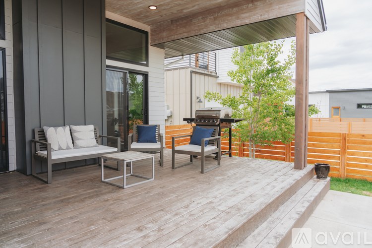 A wooden deck with a bench and a table.