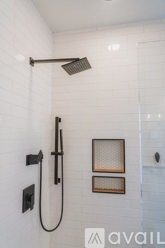 A shower head with a hose attached to it.
