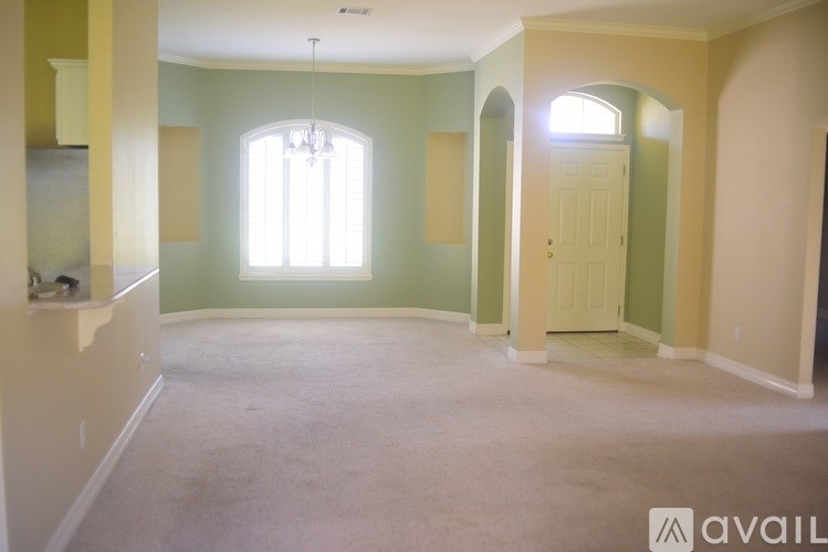 A room with a window and a door is available for rent.