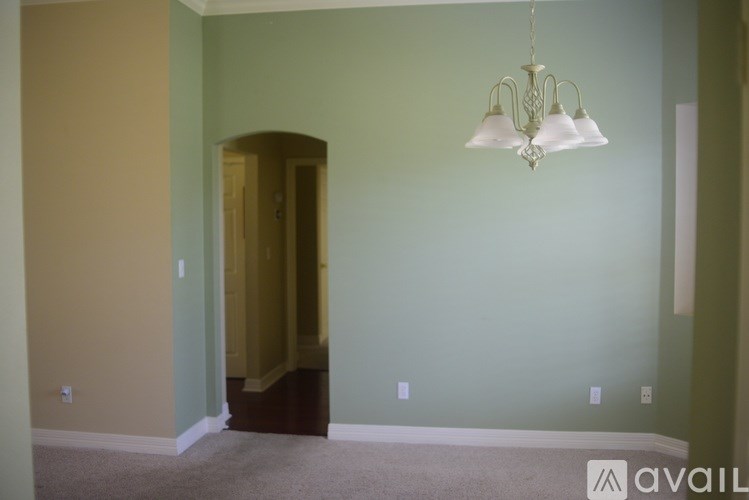 A room with a chandelier hanging from the ceiling.