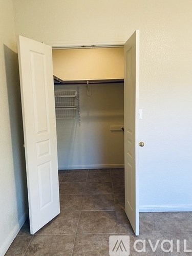 A white door is open to a small pantry.