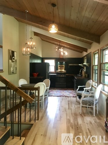 A living room with a piano and chairs.