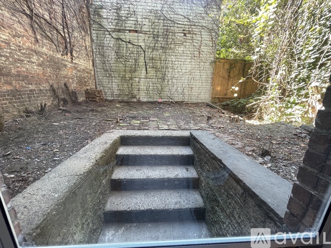 A set of stairs leads down to a dark space.