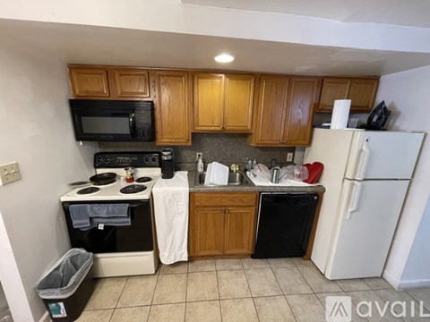 A kitchen with wooden cabinets and a white refrigerator.