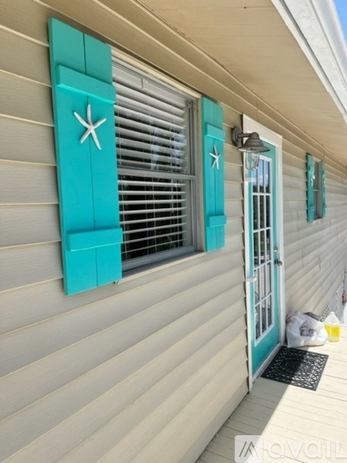 A house with a teal window frame and a white star on the window.