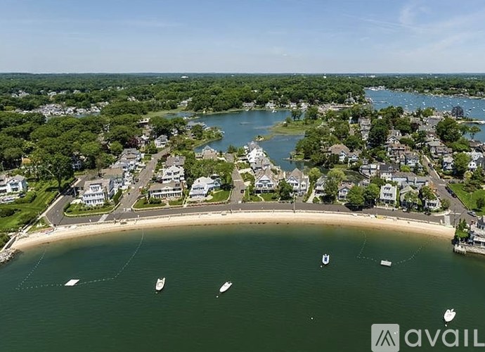 A bird's eye view of a coastal town with boats in the water.