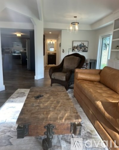 A living room with a brown couch and a wooden coffee table.