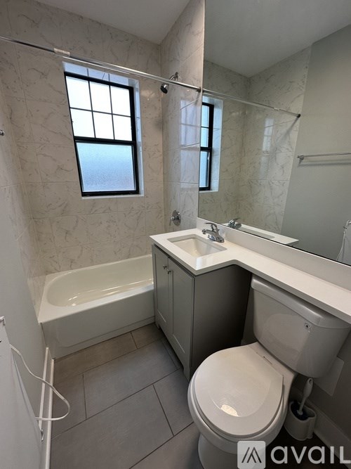 A bathroom with a tub, toilet, and sink.