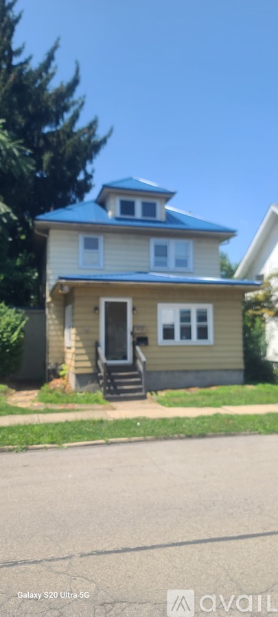 A house with a blue roof and white windows.