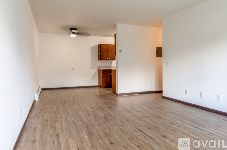 A room with wooden flooring and a ceiling fan.