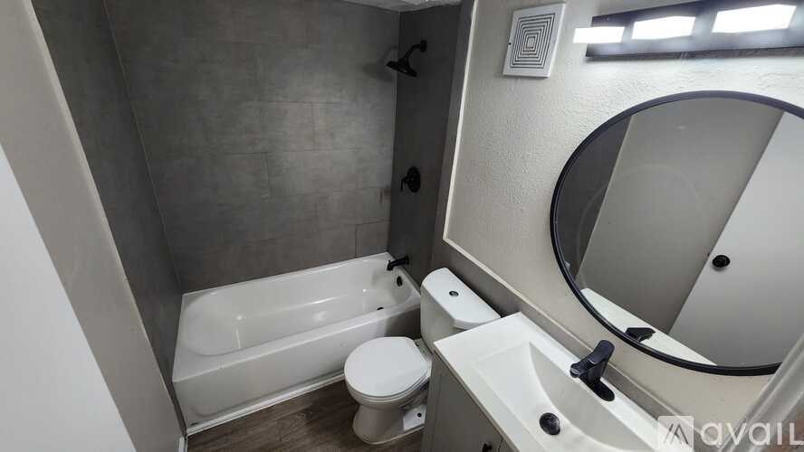 A bathroom with a toilet, sink, and tub.