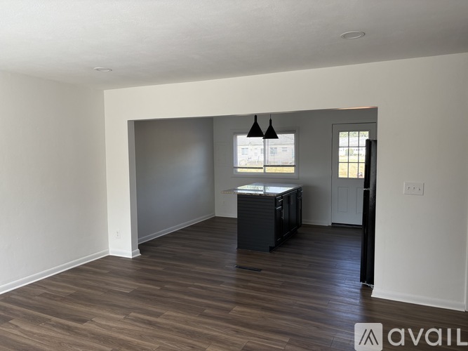 A room with wooden floors and a cabinet in it.