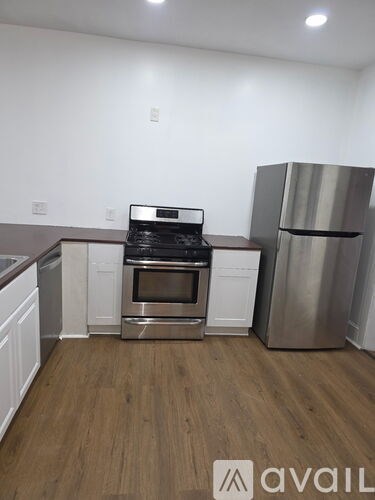 A kitchen with a stainless steel refrigerator, oven, and microwave.
