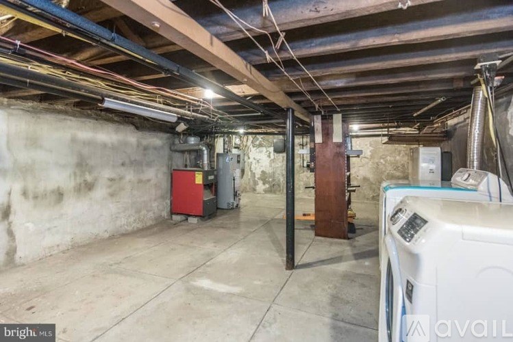 A spacious basement with a washing machine and a dryer.