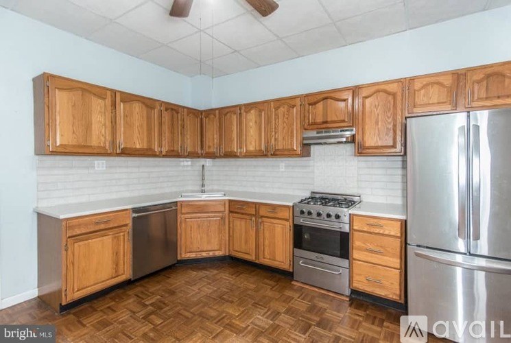 A kitchen with wooden cabinets and stainless steel appliances.
