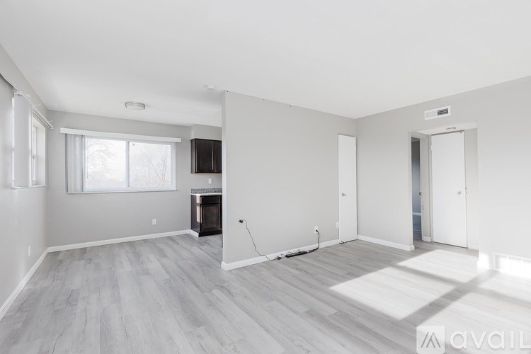 A spacious living room with a fireplace and a television.