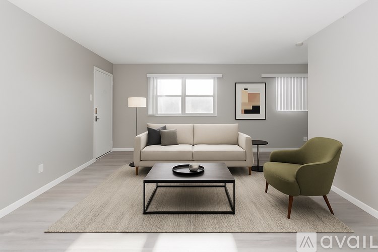 A room with a carpeted floor and a window with blinds.