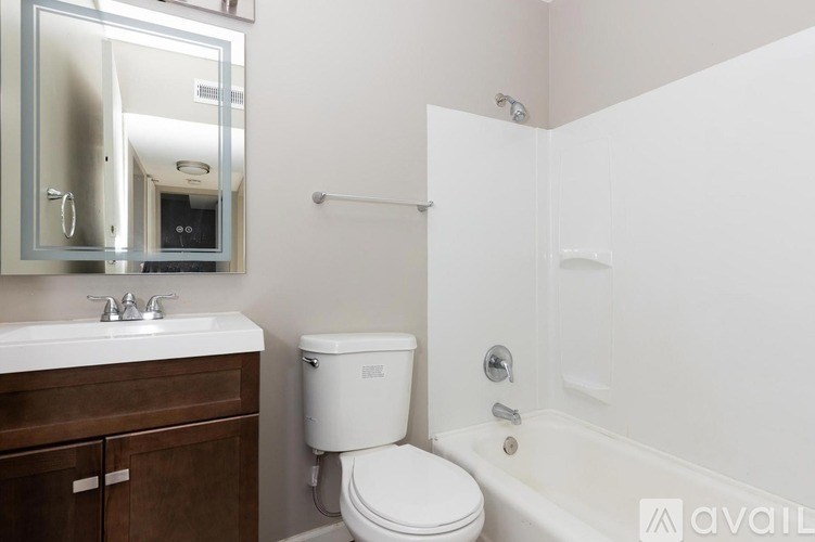 A white toilet sits next to a sink in a bathroom.
