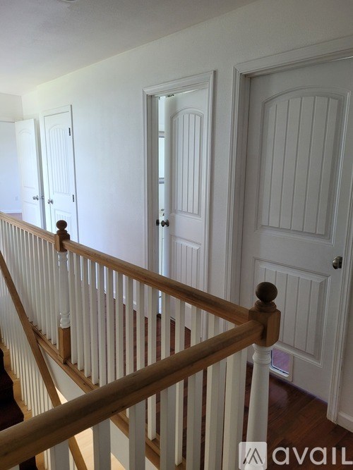 A doll stands on a staircase.