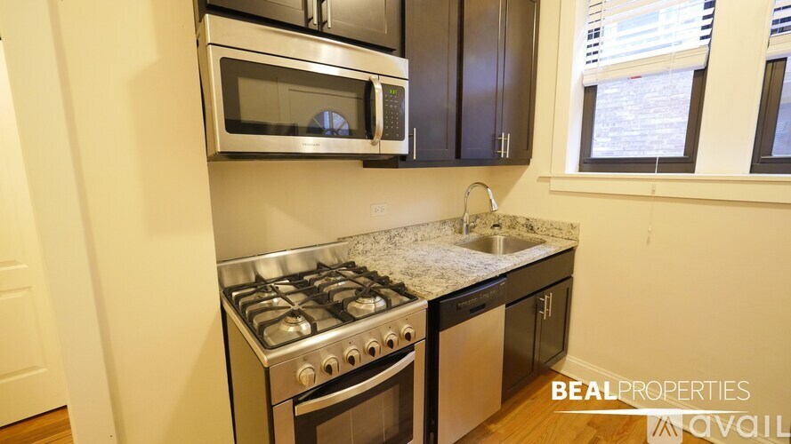 A kitchen with a stove top oven and microwave above it.