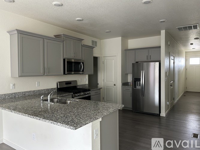 A kitchen with granite countertops and stainless steel appliances.