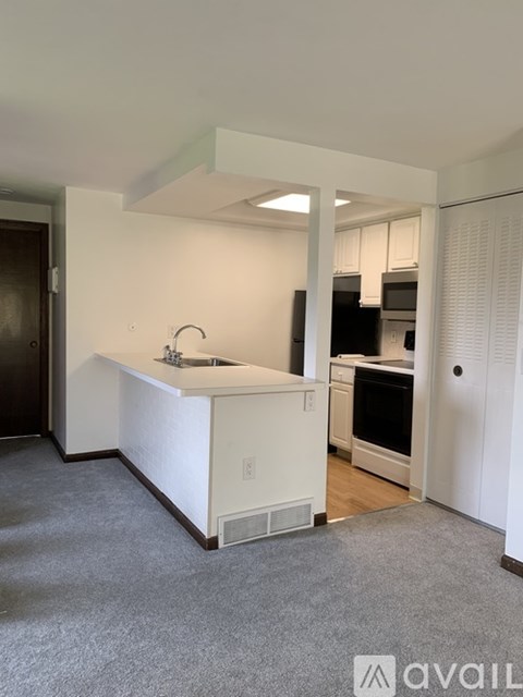 A kitchen with white cabinets and a sink.