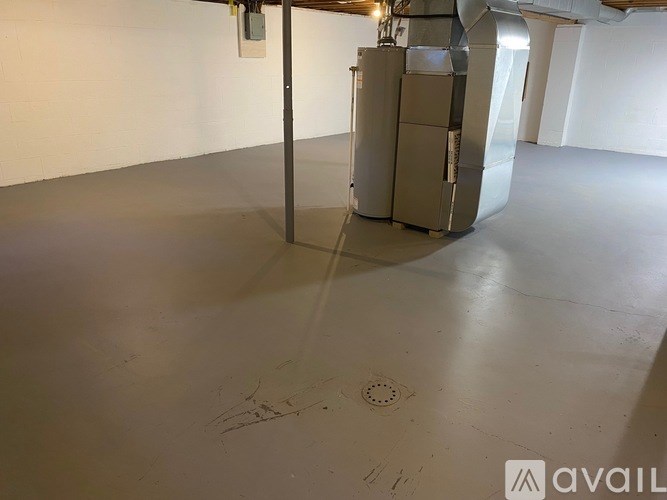 A large industrial metal object sits in a white room.