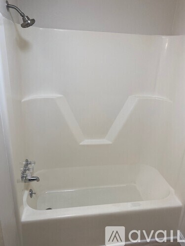 A room with wooden flooring and a window.