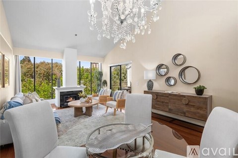 A living room with a fireplace and a chandelier.