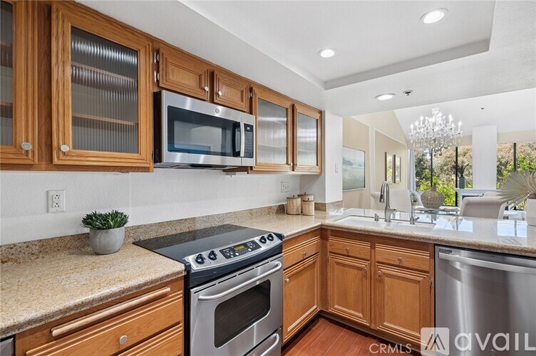 A kitchen with wooden cabinets and a stainless steel oven.