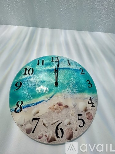 A wall clock with a beach scene design on the face.