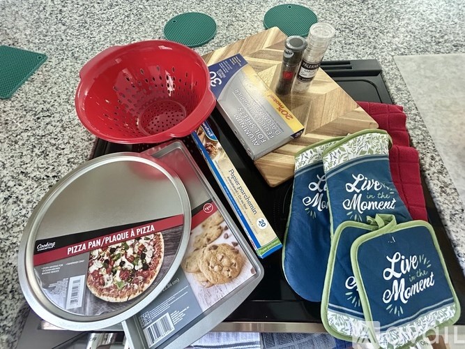 A pizza pan is on top of a pizza box.