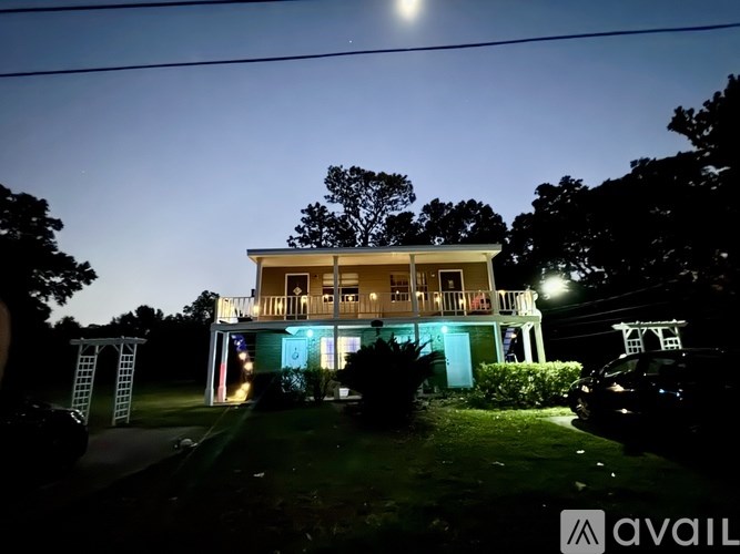 A house is lit up with blue and white lights at night.