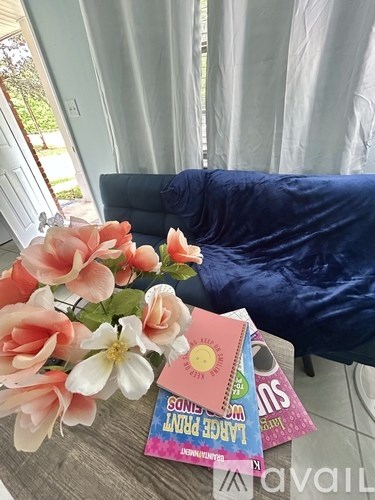 A bouquet of flowers sits on a table next to a book titled "Songs to Live By".