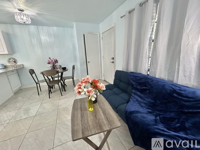 A living room with a blue couch and a wooden coffee table.