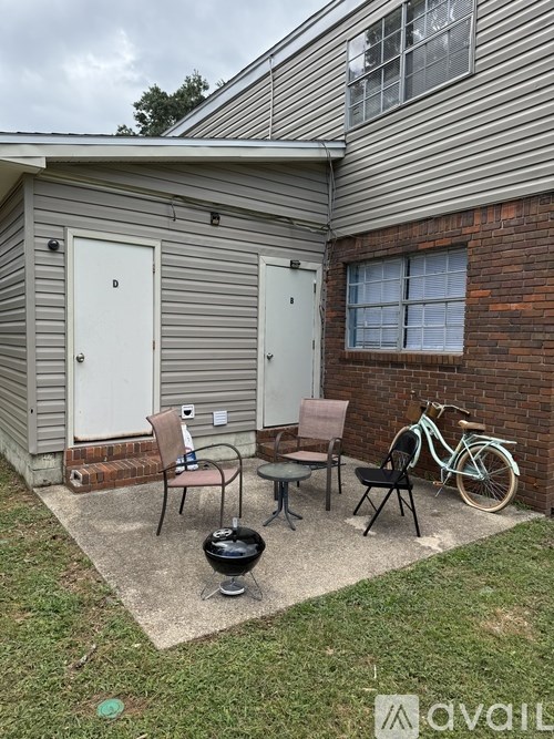 A small patio with a table, chairs, and a bicycle.
