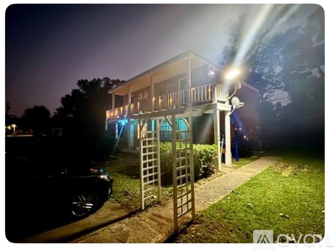 A house is illuminated by a bright light at night.