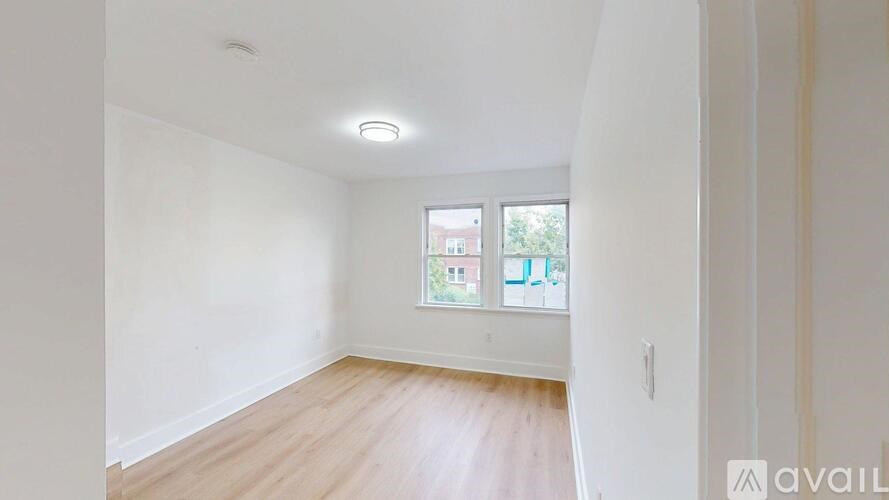 A room with a window and wooden flooring is available for rent.