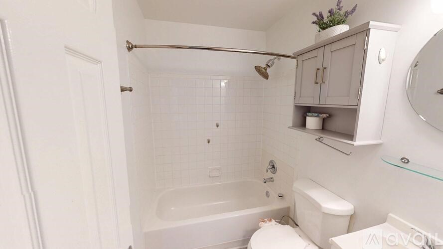 A white bathroom with a tub, toilet, and sink.