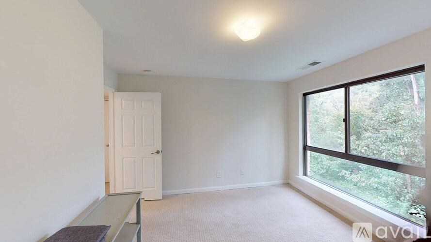 A room with a door, window, and a bench.