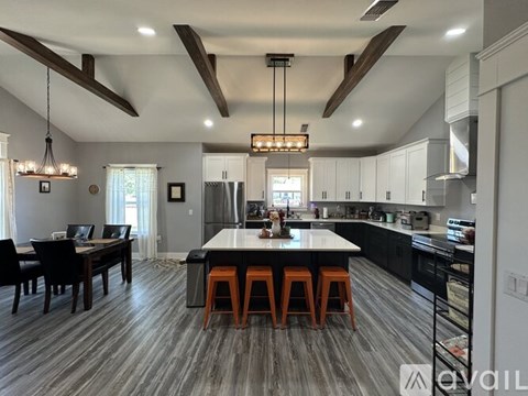 A modern kitchen with a dining table and chairs.