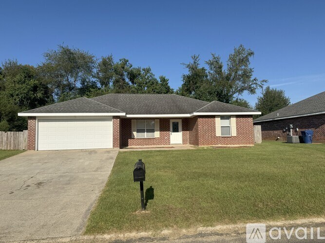 A house with a grey roof and a white garage door.