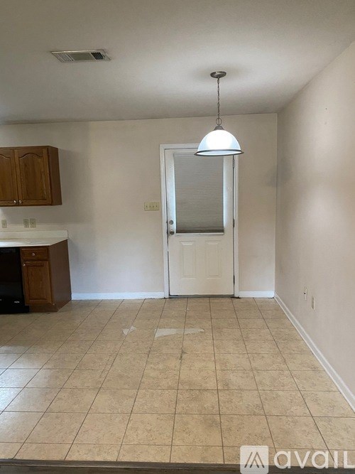 A room with a white door and a brown cabinet.