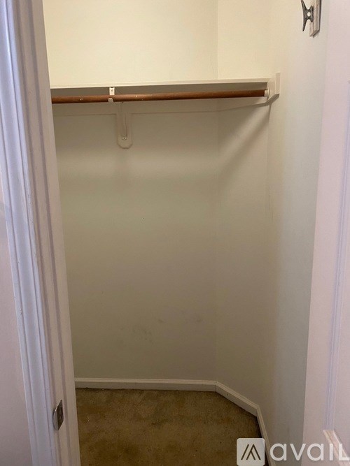 A white door with a brown shelf above it.