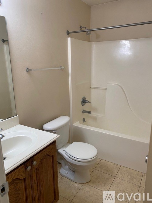 A bathroom with a toilet, sink, and bathtub.
