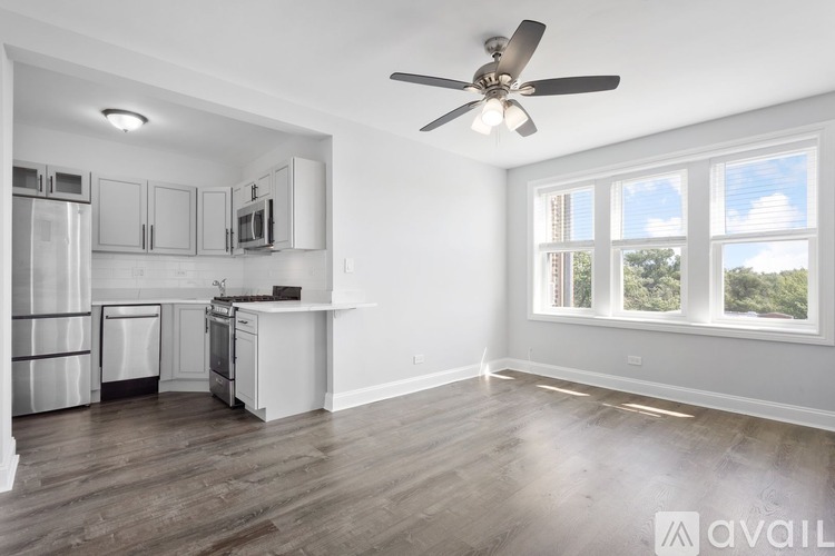 A spacious kitchen with a refrigerator, microwave, and oven.
