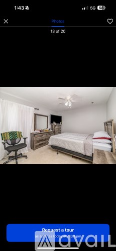 A bedroom with a bed, dresser, and chair.