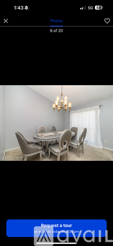 A dining room with a table set for six.