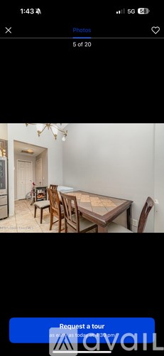 A room with a dining table and chairs.