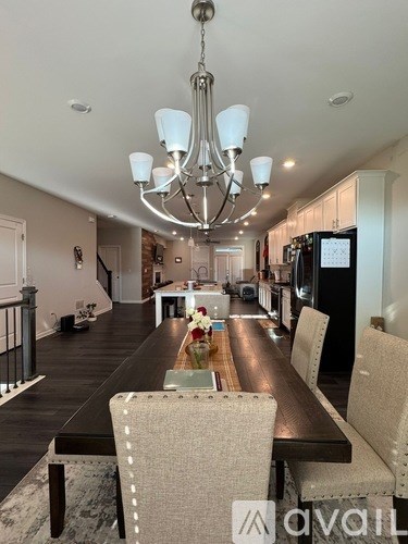 A modern dining room with a large table and chairs.